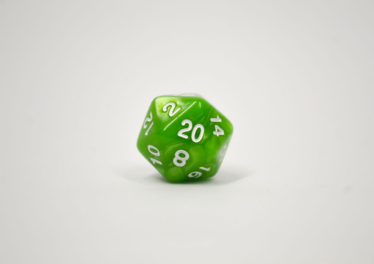 A green twenty-sided die showing the 20 face